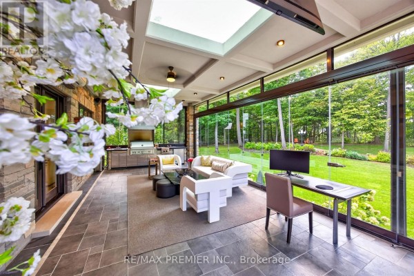 Sunroom with outdoor kitchen, modern seating, and desk - 40 Golf Avenue Vaughan