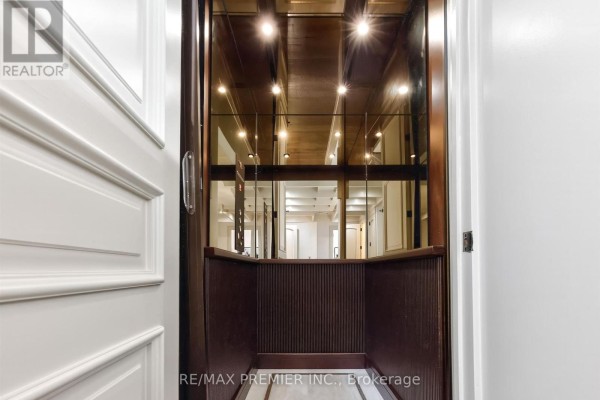 Luxury home elevator with mirrored walls and wood accents - 40 Golf Avenue Vaughan