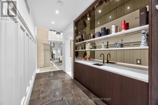 Modern bar area with sink and shelves, fireplace in hallway - 40 Golf Avenue Vaughan