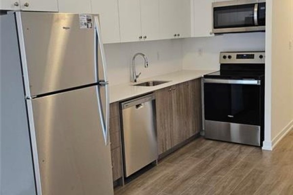 Kitchen featuring stainless steel appliances, white countertops, and light wood-look cabinetry. - 40 Palace Street Unit# J2, Kitchener