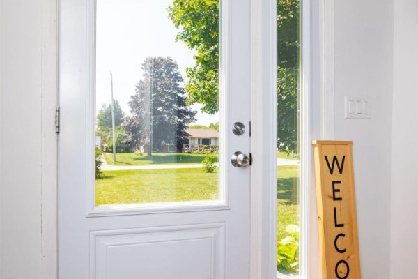 View from inside the front door looking out through glass panels to a suburban street. - 40 Poplar Drive, Cornwall