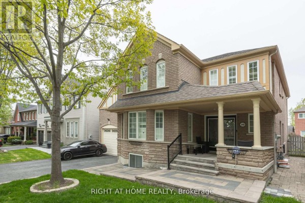 Side exterior view of a brick house with a covered porch, driveway, and lawn. - Basement - 40 Sabbe Crescent, Ajax