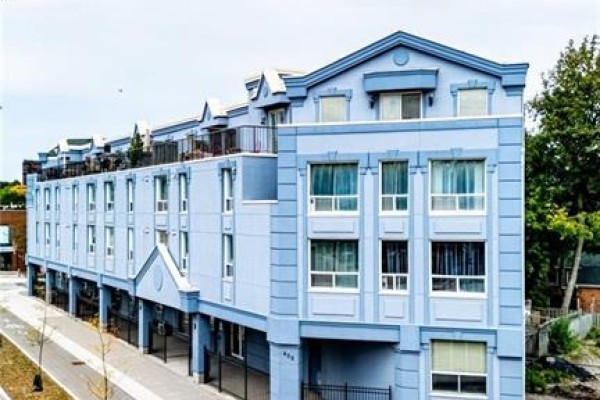Side view of a light blue apartment building showing multiple windows and balconies on different levels. - 400 York Boulevard Unit# 407, Hamilton