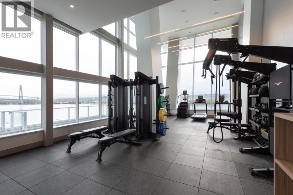 Gym with treadmills, weight machines, benches, and floor mats with large windows. - 4002 680 Quayside Drive, New Westminster