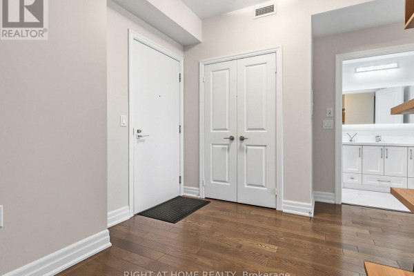The entranceway to an apartment featuring hardwood floors and a closet. - 4004 - 8 The Esplanade, Toronto
