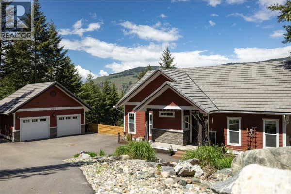 Close-up of the red house's front entrance with a stone accent. - 4006 Coachwood Close, Coldstream