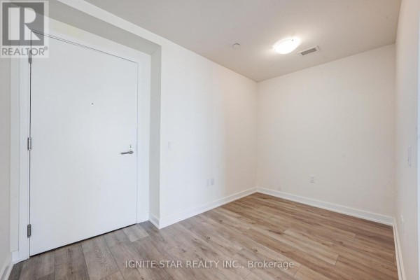 Entryway with hardwood flooring and a simple design, leading into the apartment - 4008 - 28 Freeland Street, Toronto