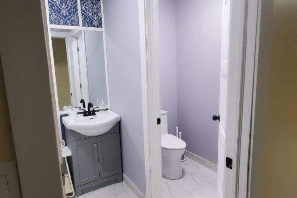 Powder room with a white toilet and a grey vanity with a white sink. - 4008 Moneymore Road, Tweed)