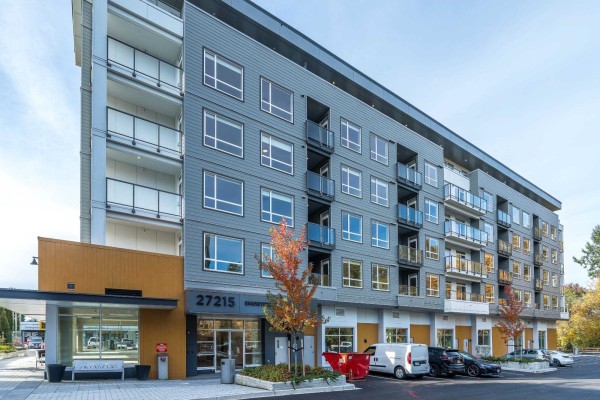 Side view of an apartment building showing multiple balconies and windows. - 401 27215 Aldergrove Town Centre Drive, Langley