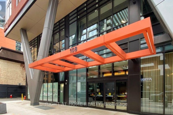 Entrance to apartment building 108 with an orange canopy and modern architectural supports. - 4013 - 108 Peter Street, Toronto