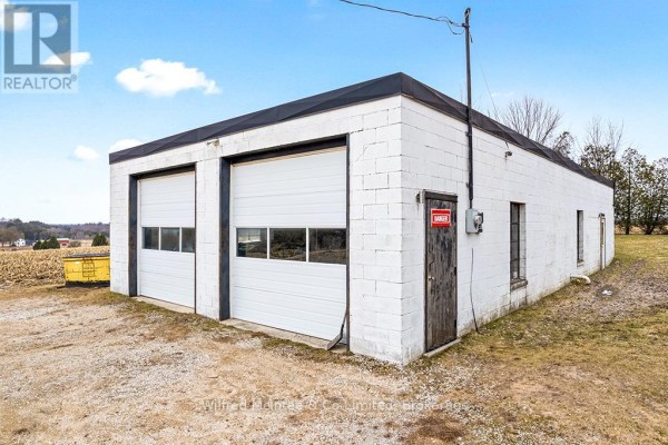 Building with two garage doors and a 'DANGER' sign - 401395 Grey Rd 4 West Grey
