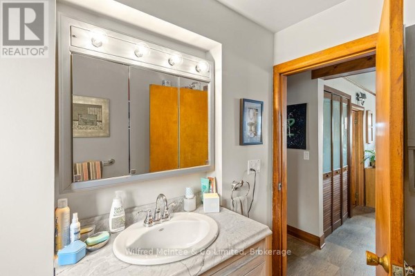 Bathroom vanity, sink, and medicine cabinet with wood trim doorways - 401395 Grey Rd 4 West Grey