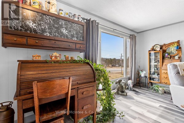 Roll-top desk, display cabinet, and elephant figurines in a living room - 401395 Grey Rd 4 West Grey