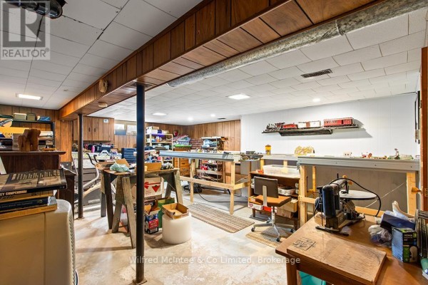 Model train display and workbenches in a finished basement - 401395 Grey Rd 4 West Grey