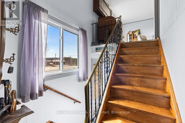 Wooden staircase with wrought iron banister and window view of rural landscape - 401395 Grey Rd 4 West Grey