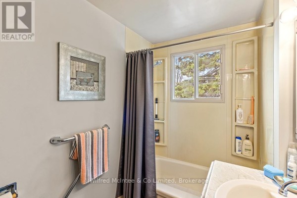 Dated bathroom with bathtub, sink, and window - 401395 Grey Rd 4 West Grey