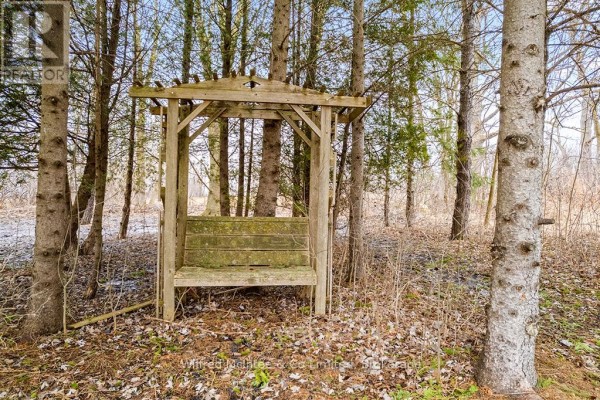 Wooden gazebo with bench in yard with trees - 401395 Grey Rd 4 West Grey