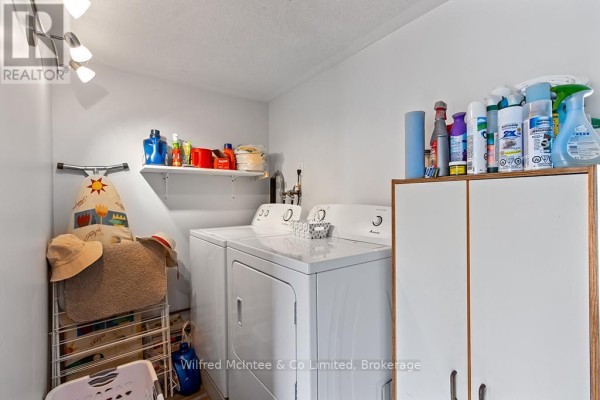 Laundry room with washer, dryer, and storage cabinet - 401395 Grey Rd 4 West Grey