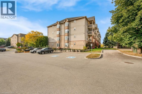 Side exterior view of apartment building with parking lot and trees with fall foliage. - 4015 Kilmer Drive Unit# 204, Burlington