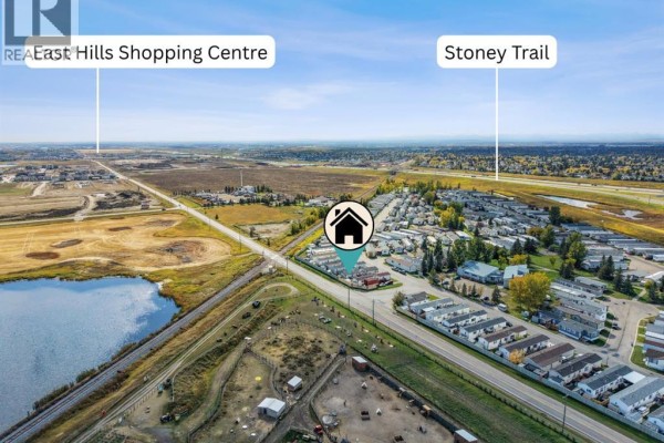 Aerial view showing the property's location relative to East Hills Shopping Centre and Stoney Trail. - 402, 1101 84 Street Ne, Calgary