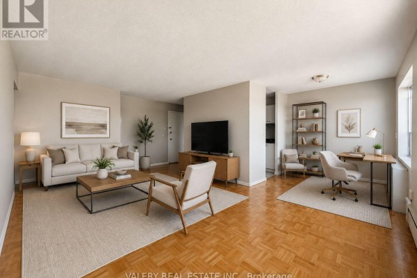 Living room with light grey walls, beige carpet, hardwood floors, and sofa. - 402 - 1780 Lawrence Avenue E, Toronto