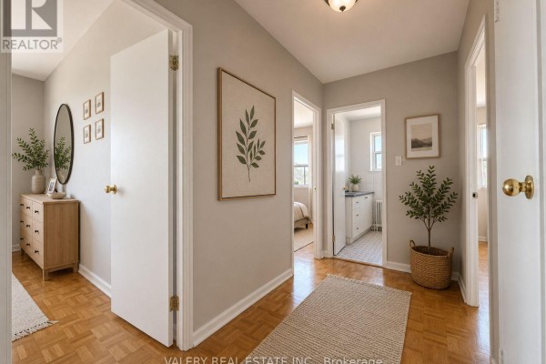 Hallway connecting rooms, featuring light grey walls, wood floors, and a dresser. - 402 - 1780 Lawrence Avenue E, Toronto