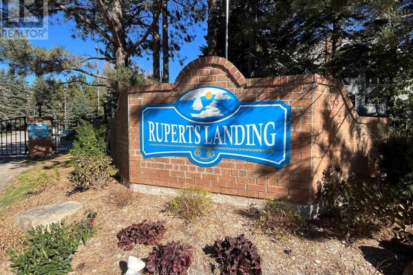 Entrance sign for Ruperts Landing, made of brick with a blue emblem. - 402 - 24 Ramblings Way, Collingwood