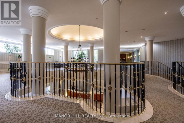Second floor view of the building lobby with ornate railings, columns, and chandelier hanging in a domed ceiling. - 402 - 35 Kingsbridge Garden Circle, Mississauga