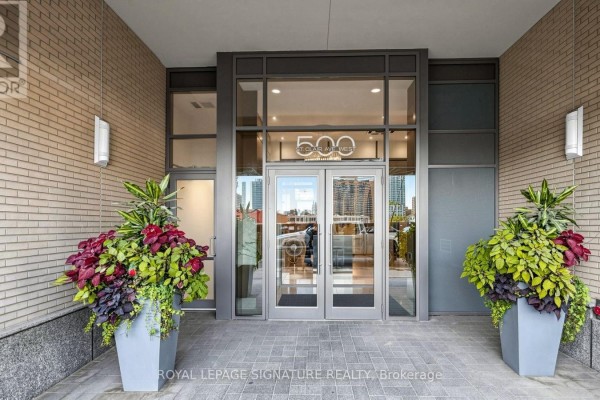 Main entrance of the apartment building at 500 St Clair Avenue West with double glass doors. - 402 - 500 St Clair Avenue W, Toronto