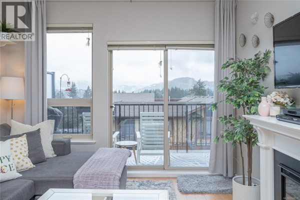 Entryway leading to an open-concept living area with a view. - 402 3240 Jacklin Rd, Langford