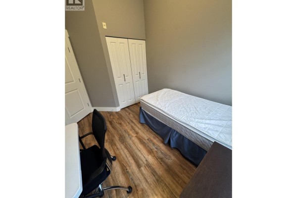 A spacious balcony with a glass railing and views of trees. - 402 6328 Larkin Drive, Vancouver