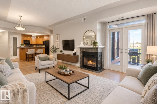 Entryway with kitchen view, wooden cabinets, and stainless steel appliances. - #402 9020 Jasper Av Nw, Edmonton