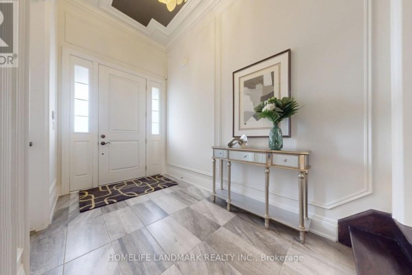 Foyer with marble tile flooring, a console table, and a large double door. - 402 Farrell Road, Vaughan