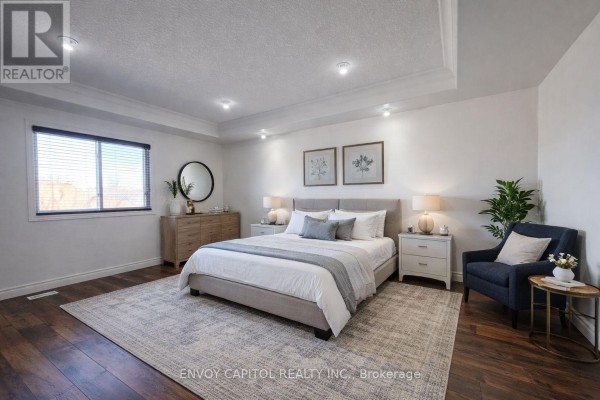 Modern bedroom with hardwood floors, tray ceiling, and recessed lighting - 402 Palamino Place, Waterloo