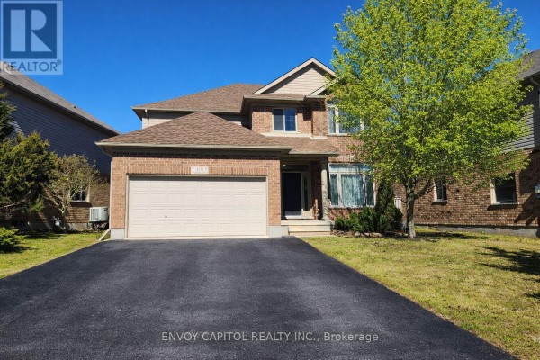 Two-story brick house with attached garage & paved driveway - 402 Palamino Place Waterloo