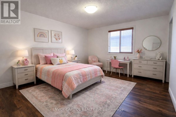 Bedroom with hardwood floors, window, desk, dresser - 402 Palamino Place Waterloo