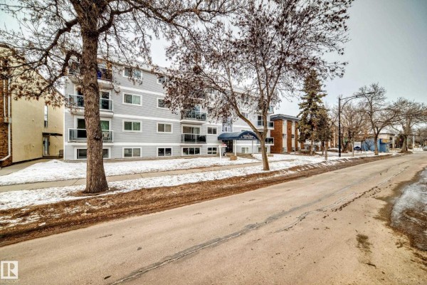 Side view of Brisdon Manor with snow on the ground and surrounding trees. - #403 10624 123 St Nw, Edmonton