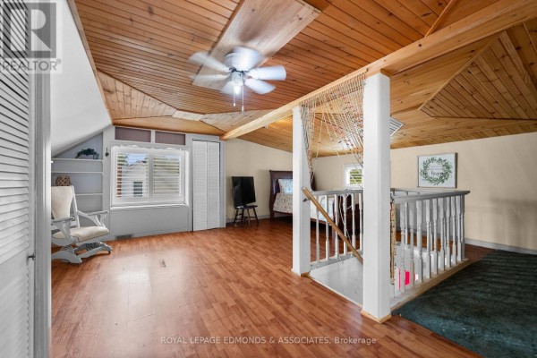Bedroom with wood plank ceiling, fan, rocking chair, and bed - 403 Alfred Street Pembroke