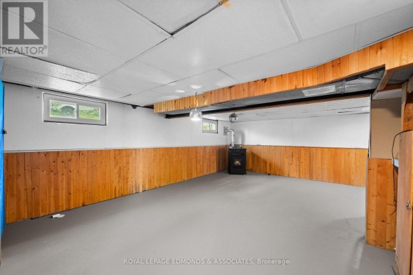Finished basement with wood paneling and wood stove - 403 Alfred Street Pembroke