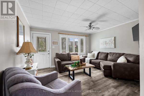 Living room with sectional sofa, armchair, and coffee table - 403 Alfred Street Pembroke