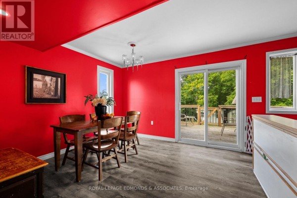 Wooden dining set with red walls and deck access - 403 Alfred Street Pembroke