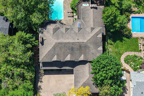 View of two multi-level balconies with dark railings overlooking the backyard pool area. - 403 Bay Street, Orillia