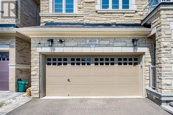 Close-up of a beige double garage door on a stone house. - 4039 Eternity Way, Oakville