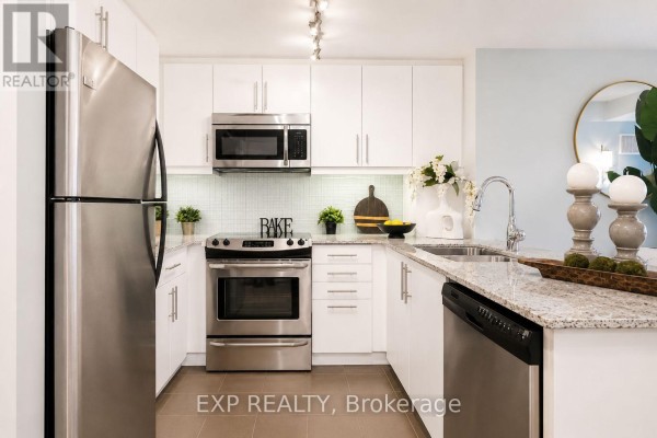 Home office with desk, computer monitors, black office chair, and digital piano. - 404 - 500 St Clair Avenue W, Toronto