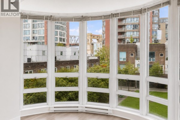 A long, shallow water fountain with surrounding landscaping and tall buildings. - 404 1501 Howe Street, Vancouver