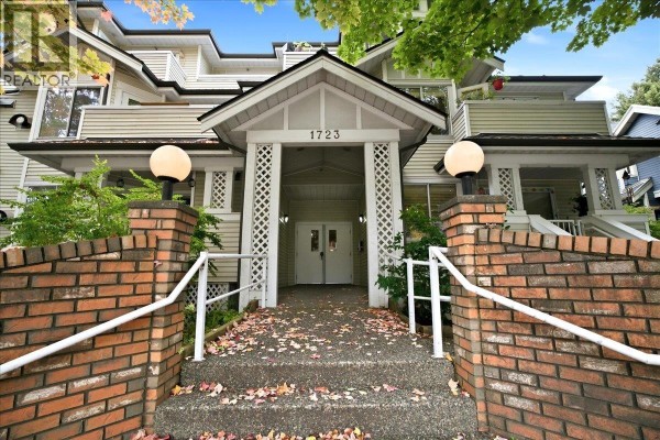 Exterior of apartment building entrance with brick pillars and covered walkway. - 404 1723 Frances Street, Vancouver