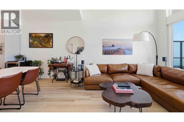 Living room with dining area, brown leather chairs, and a sectional sofa. - 414 1892 Starling Drive, Tsawwassen