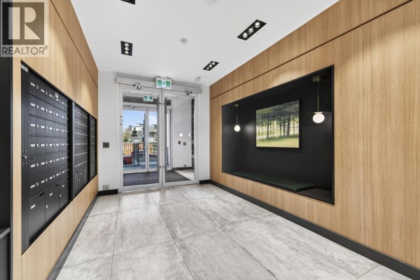 Apartment interior hallway with white walls, wood-look floor, doors, and a full-length mirror. - 404 648 Lea Avenue, Coquitlam