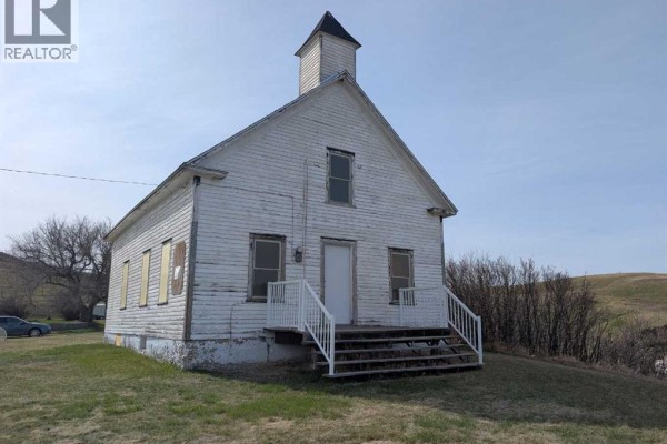 Frontal view of a white wooden church with a steeple, white steps, and a white door. - 404 Hillside Avenue, Carbon