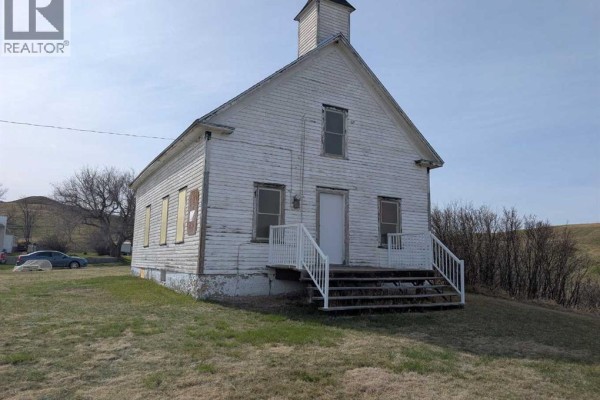 Slightly angled view of a white wooden church with a steeple and surrounding landscape. - 404 Hillside Avenue, Carbon